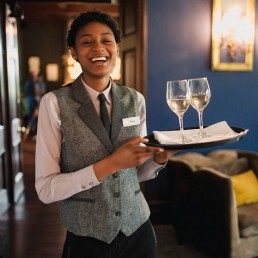 bar lady carrying wine on tray