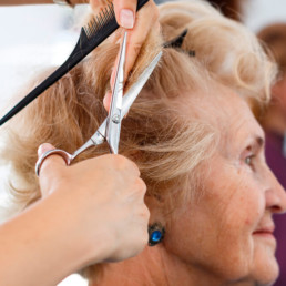 Older woman having a haircut